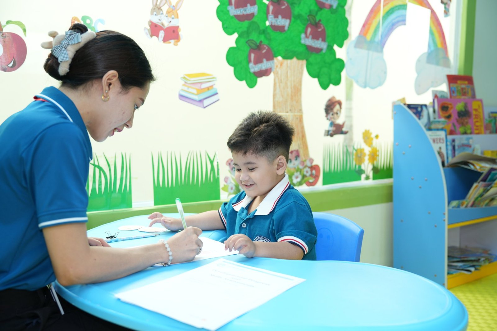 A teacher supporting a child’s learning