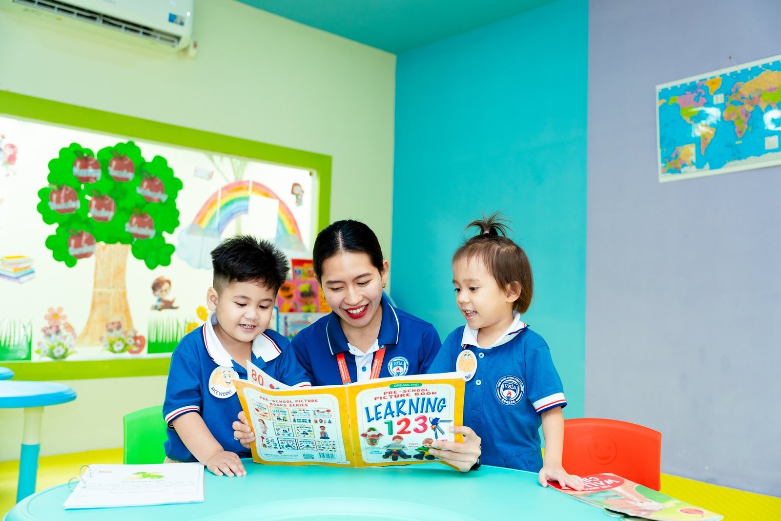 A teacher and children reading together